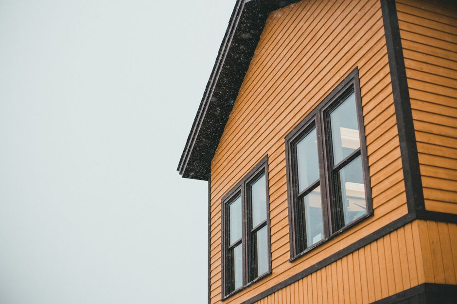 Close view of a house exterior with dark window trim