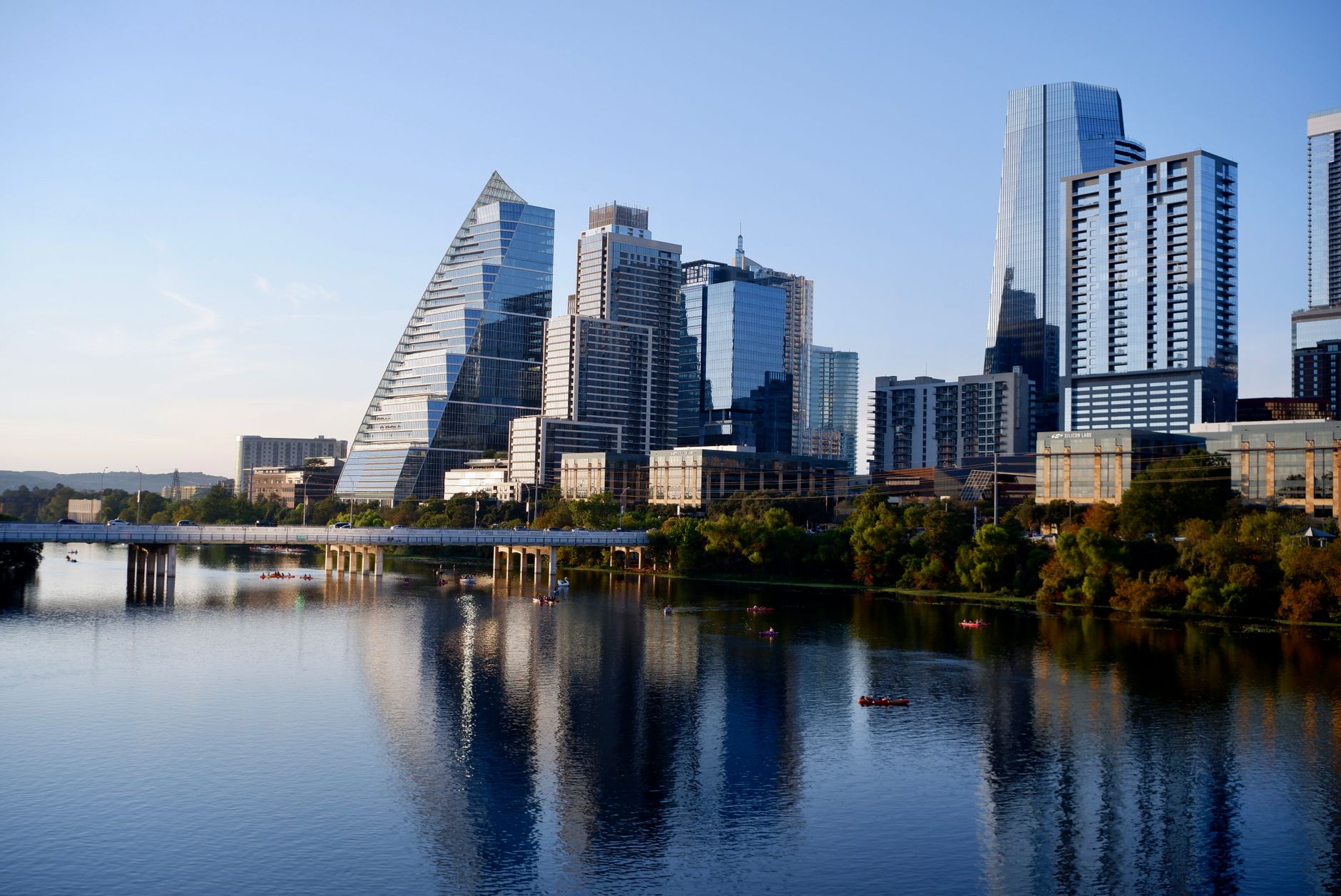 Stunning view of Austin's modern skyline reflecting on Lady Bird Lake during daylight