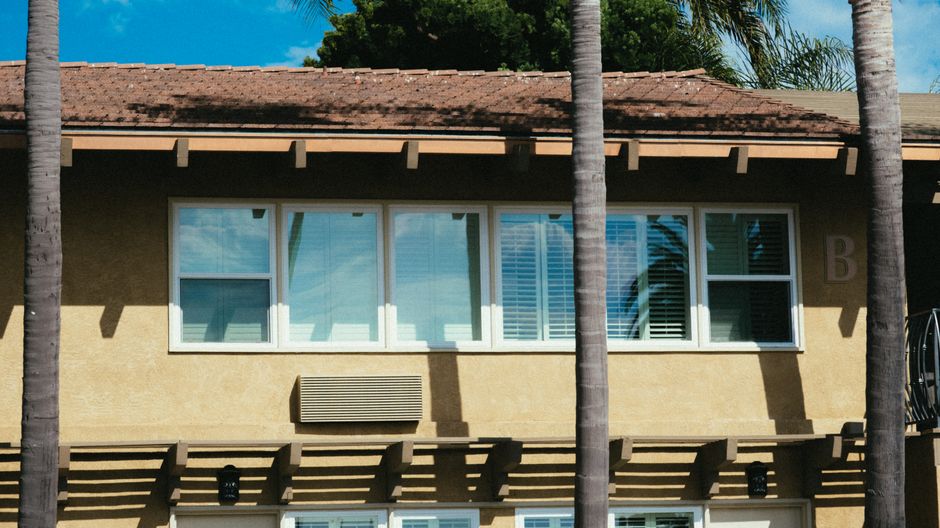 Front of a modern house with large windows under a clear sky