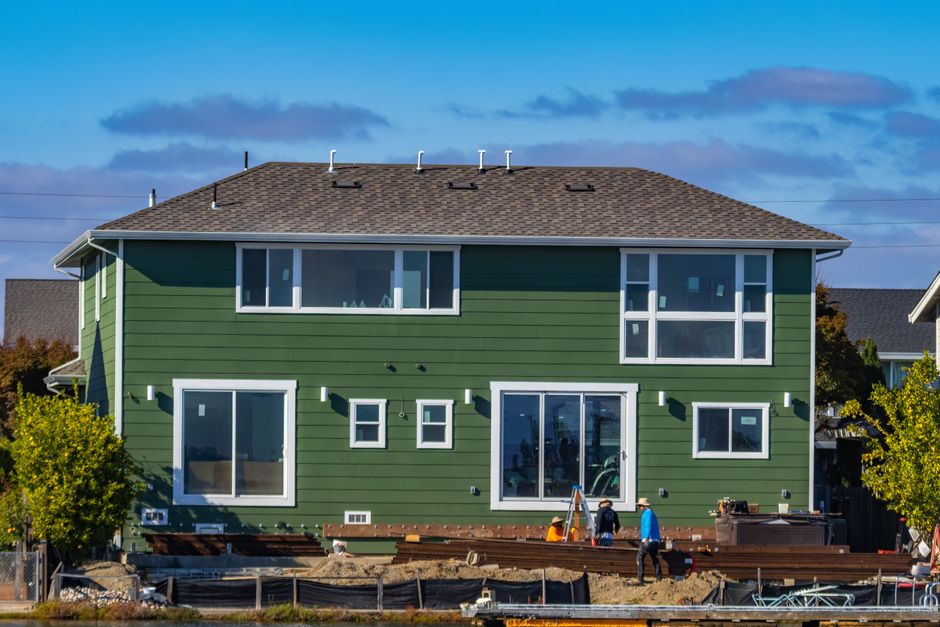 House exterior with new windows under a clear sky